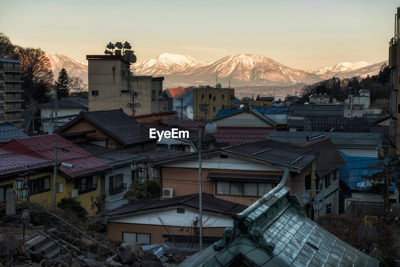 Aerial view of shibu onsen town and central alps mountain at sunrise, yamanouchi, nagano, japan.