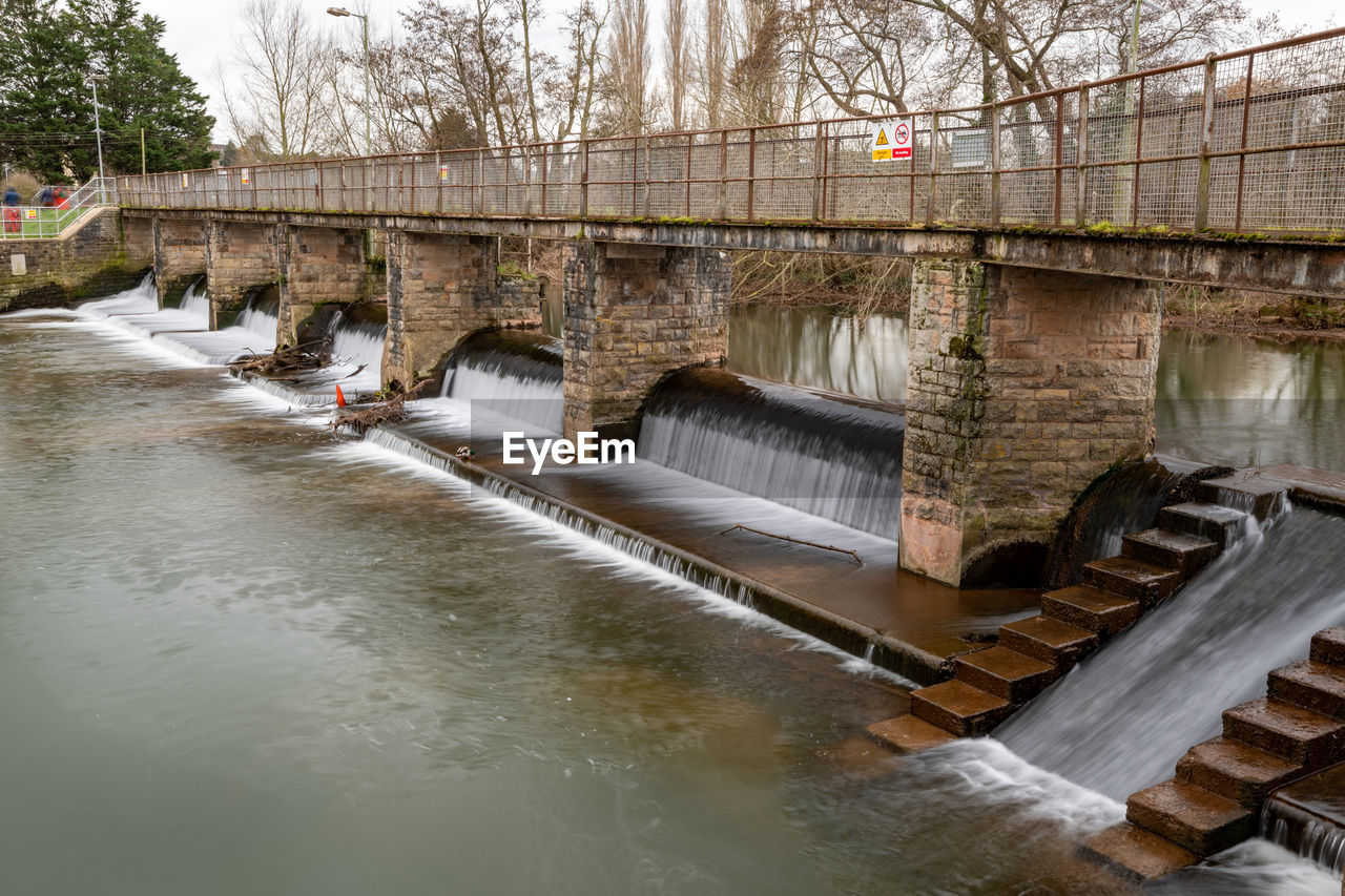 water, architecture, built structure, bridge, tree, river, nature, waterway, hydroelectric power, dam, no people, day, plant, flowing water, power generation, outdoors, building exterior, environmental conservation, environment, flood, reflection, waterfront