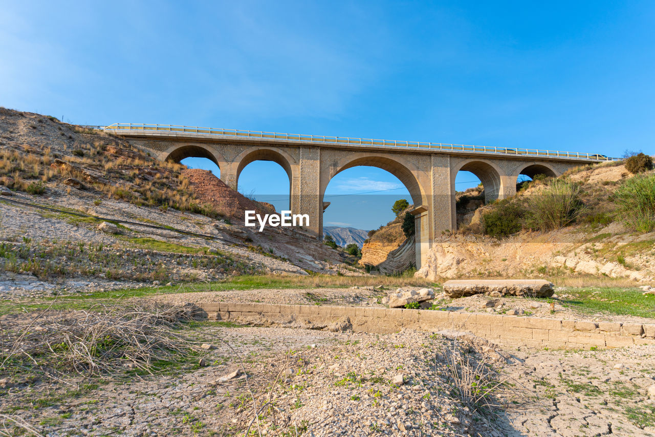 Bridge over a dry river, mountainous nature and drought environment.