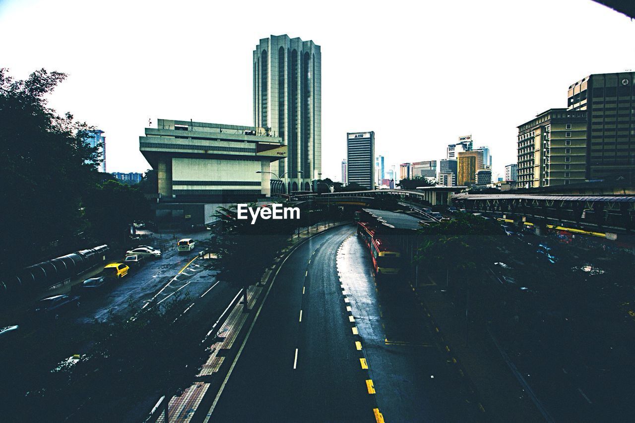 Empty road along buildings