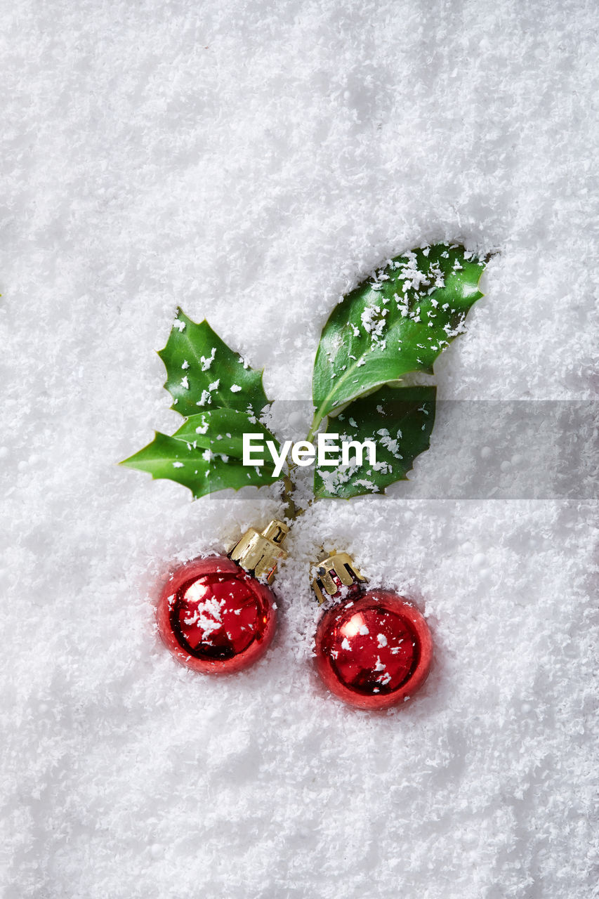 Directly above shot of christmas ornaments on fake snow