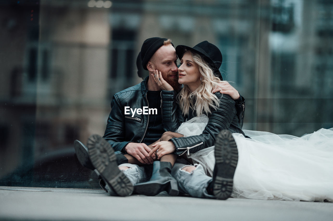 Young couple sitting outdoors