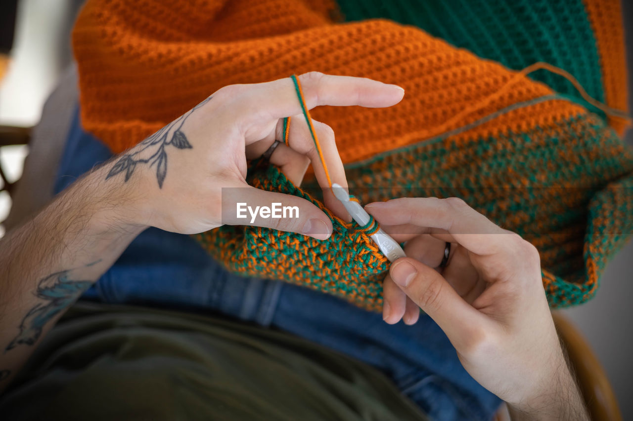 midsection of man holding wedding dress