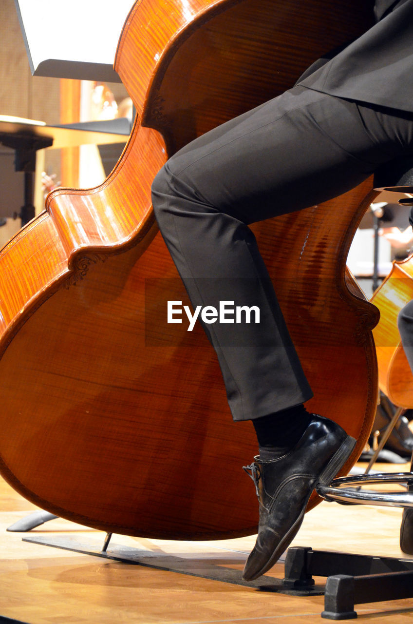 Low section of musician playing double bass