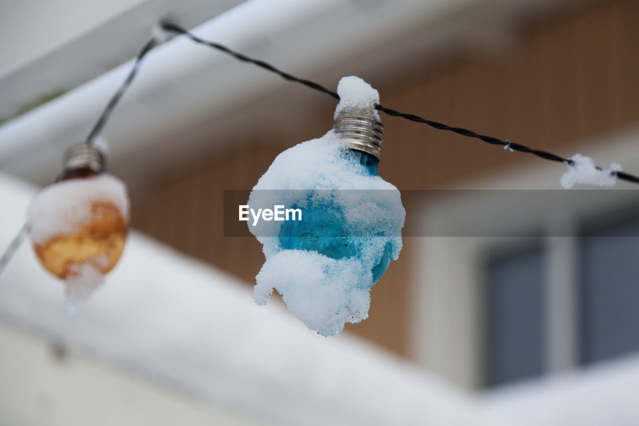 LOW ANGLE VIEW OF ICE CREAM HANGING OVER SNOW