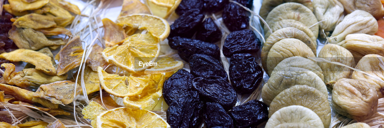 Dried fruit background. rows of dried dates, apricots, lemon, prunes and figs.