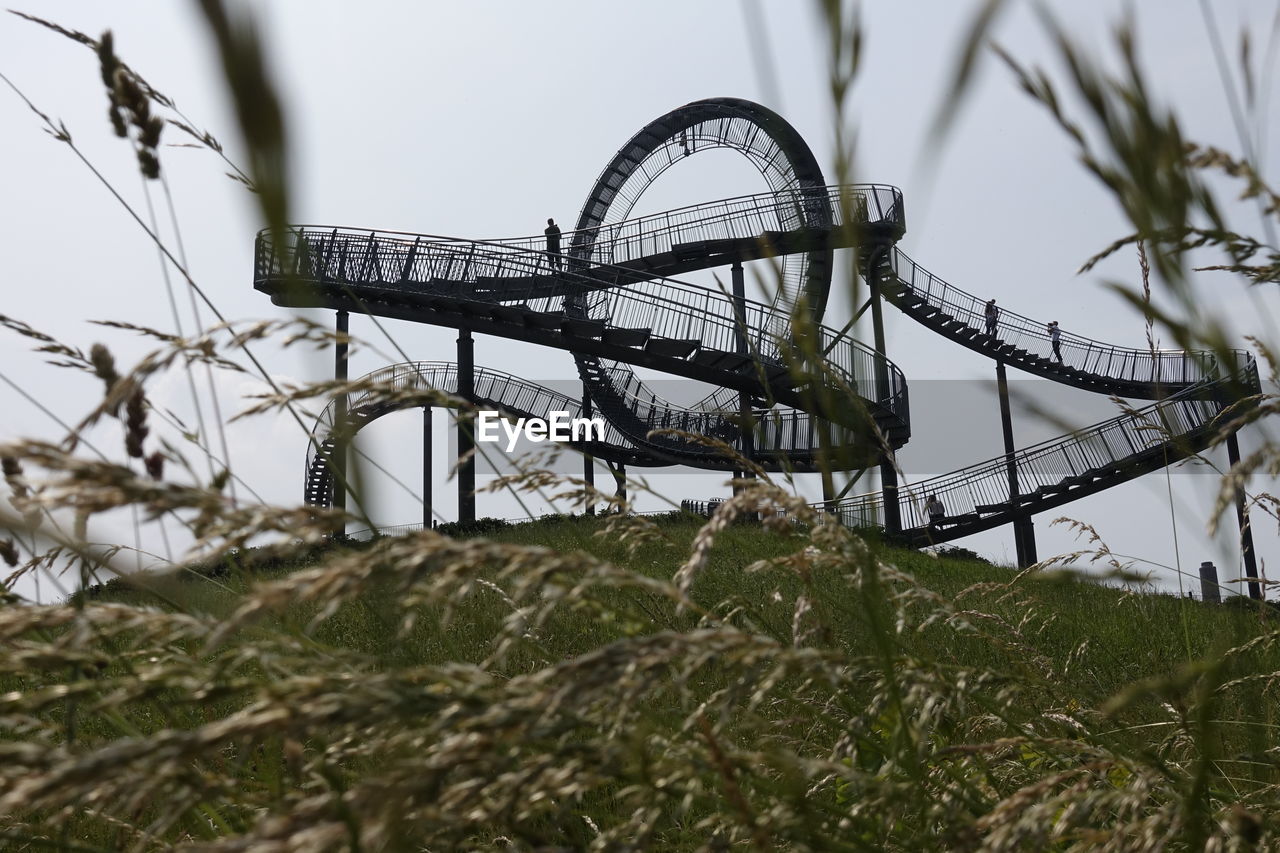 LOW ANGLE VIEW OF AMUSEMENT PARK RIDE AGAINST SKY