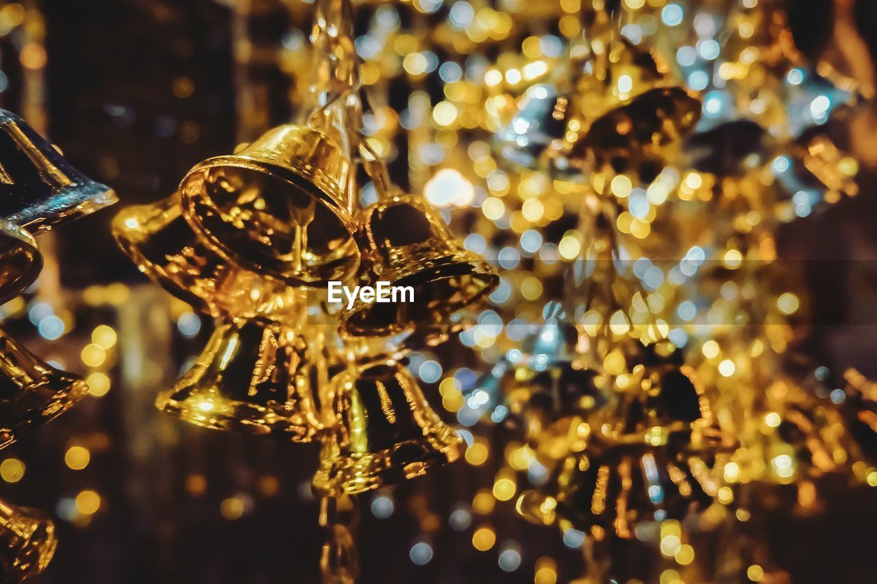 Close-up of illuminated christmas decoration, golden bells.