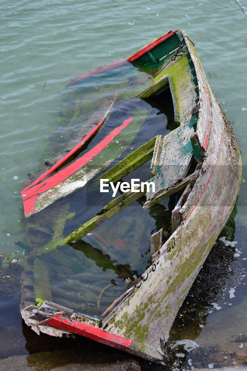 Abandoned boat moored in lake