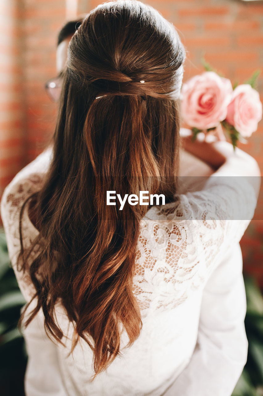 Rear view of woman embracing man during wedding