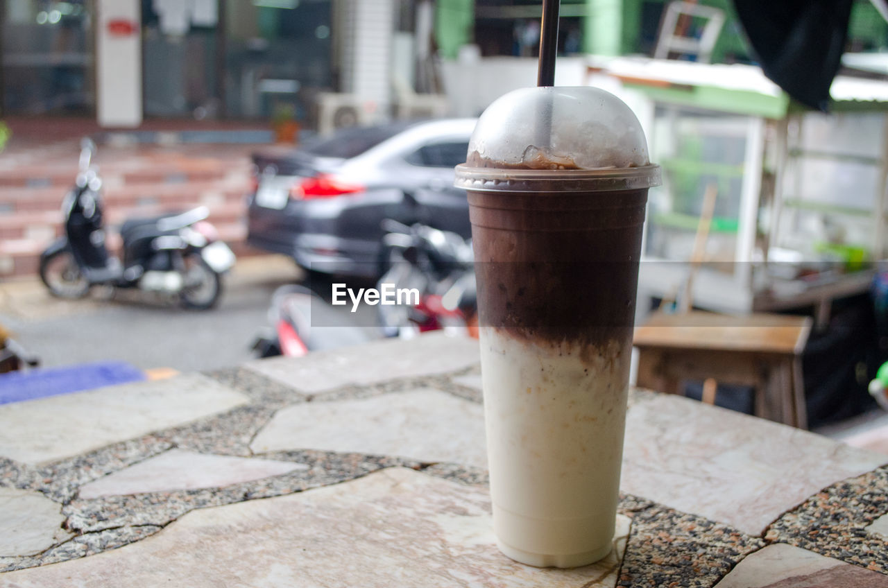 Close-up of coffee served on table in city