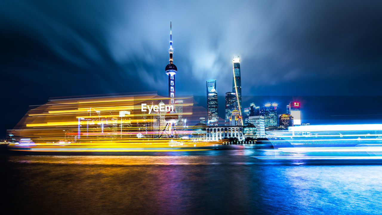 Illuminated buildings against sky at night