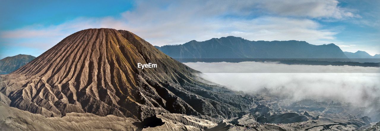 Scenic view of mountains against cloudy sky