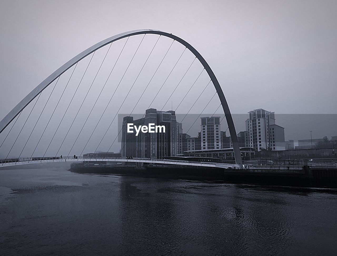 Bridge over river with buildings in background