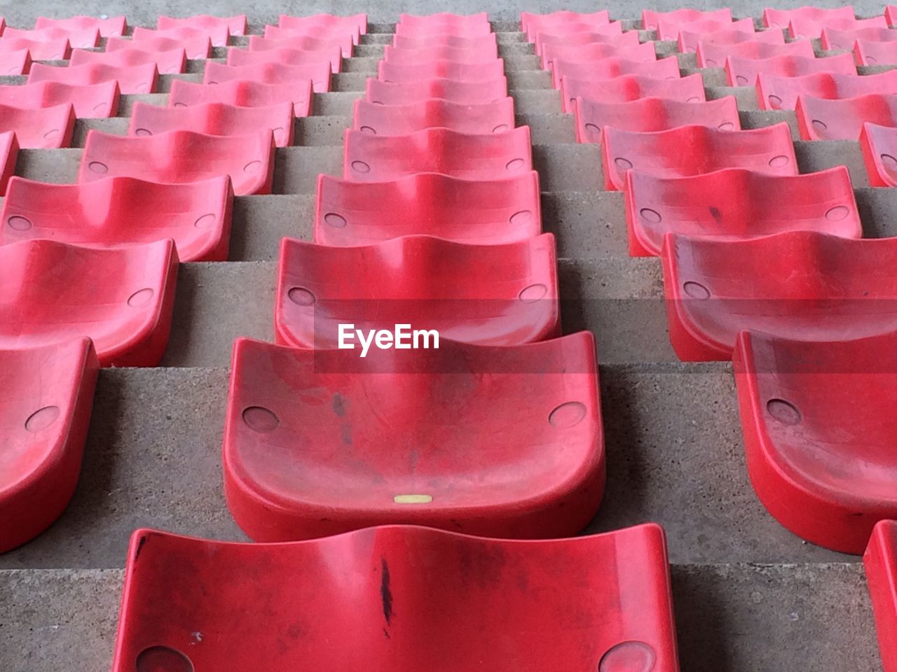 Full frame shot of red seats arranged in stadium