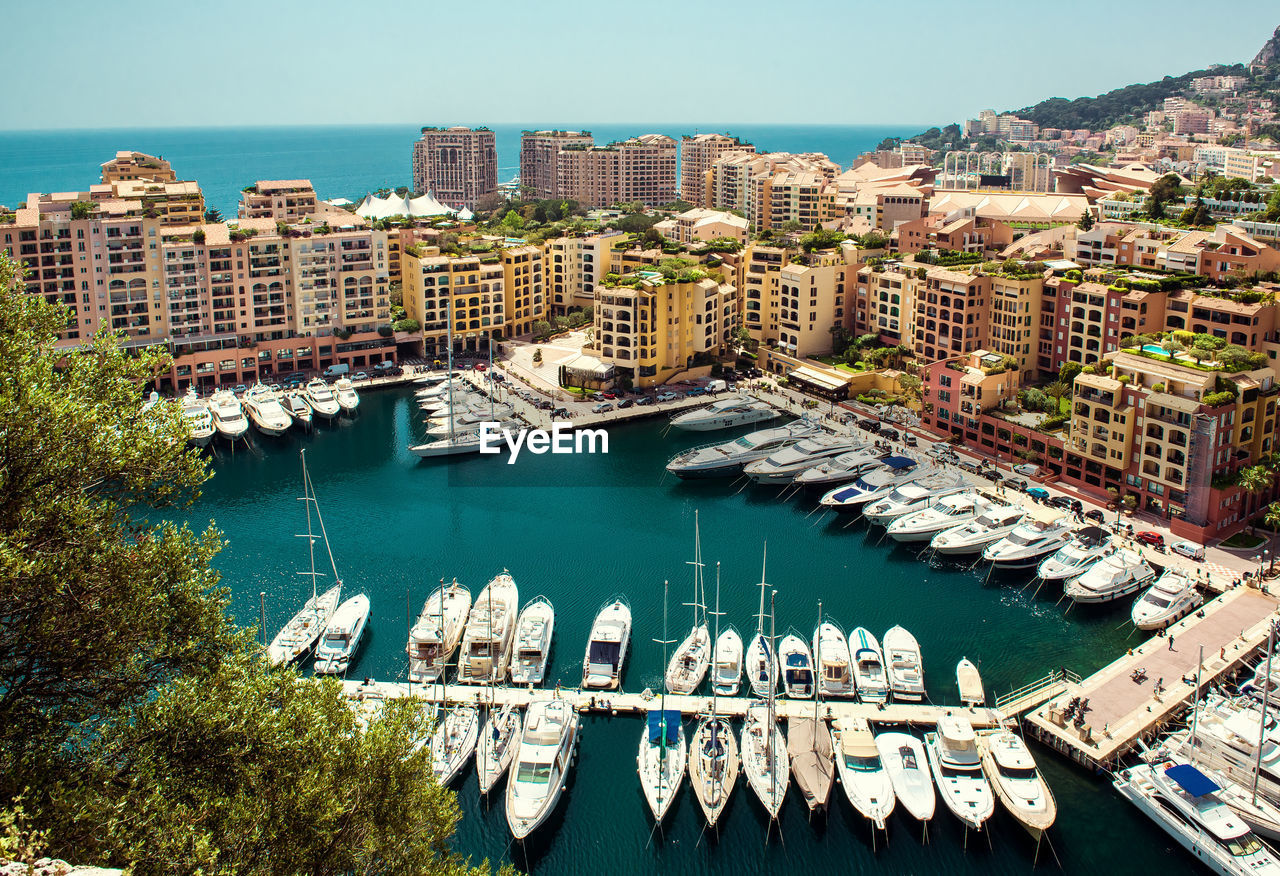 High angle view of city by sea against clear sky