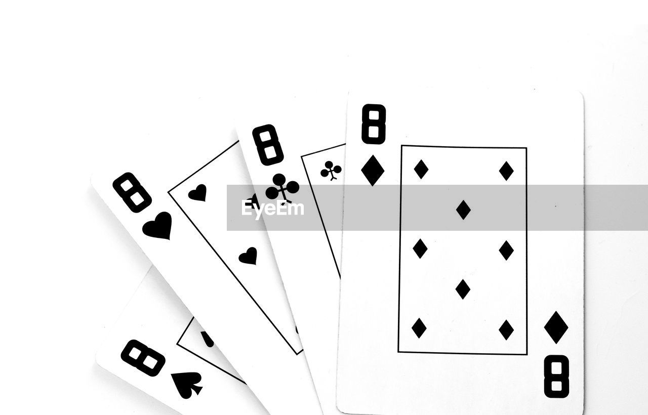 Close-up of playing cards against white background