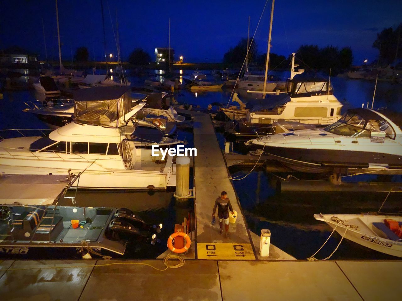 BOATS MOORED AT HARBOR