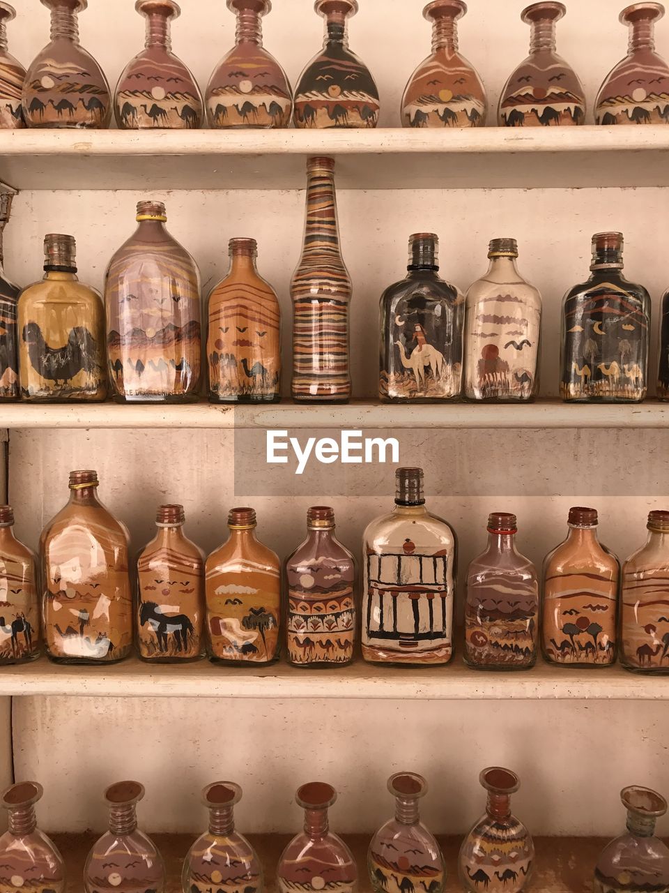Sand in bottles crafts on shelf in petra, jordan