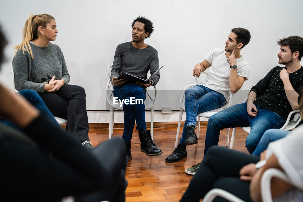 Colleagues discussing in meeting at office