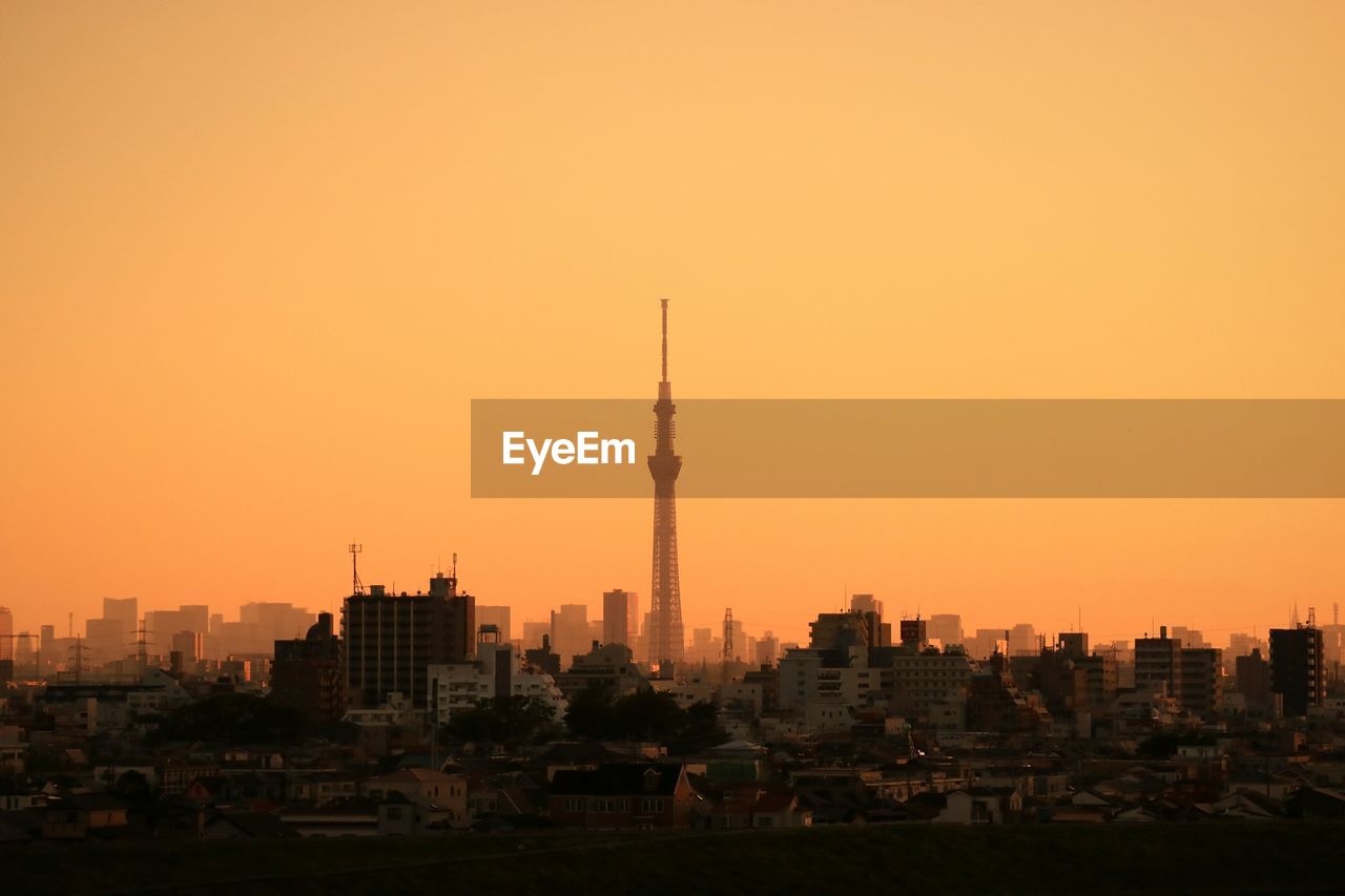 Tokyo sky tree against sky during sunset in city