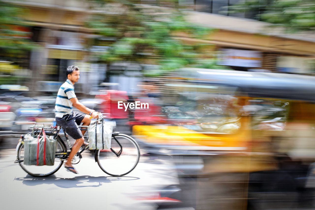 Man riding bicycle on street in city