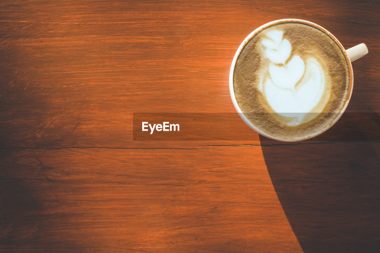 High angle view of coffee on wooden table