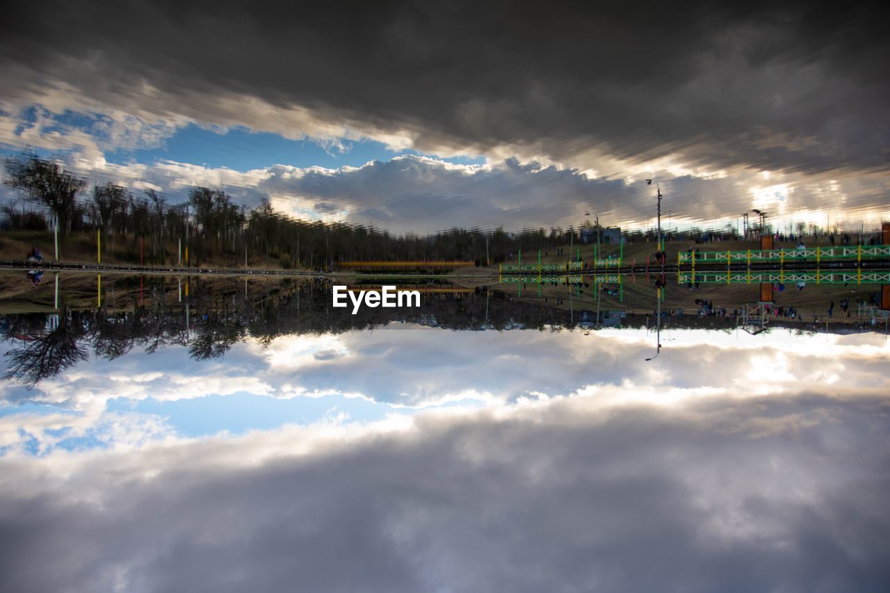 SCENIC VIEW OF LAKE AGAINST CLOUDY SKY