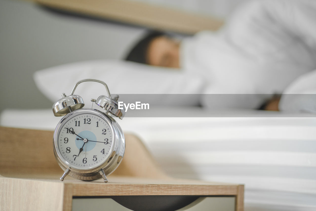 Close-up of man sleeping on bed at home