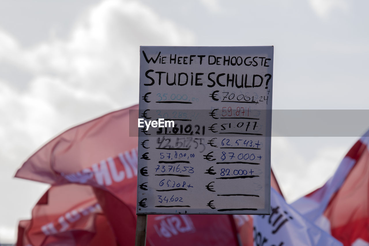 text, cloud, communication, flag, sky, western script, day, patriotism, sign, outdoors, nature, no people