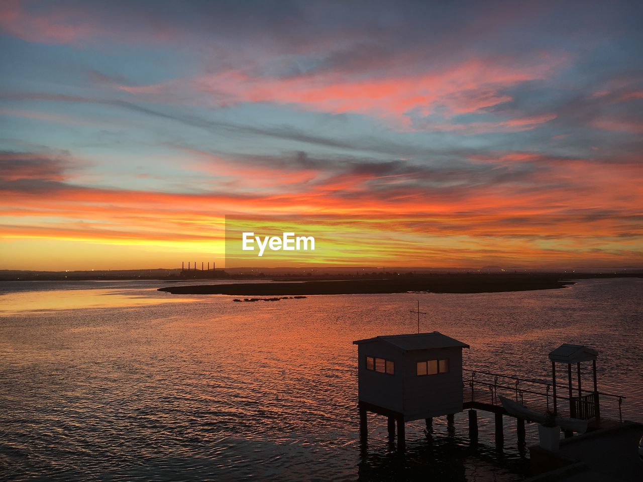 Scenic view of sea against orange sky