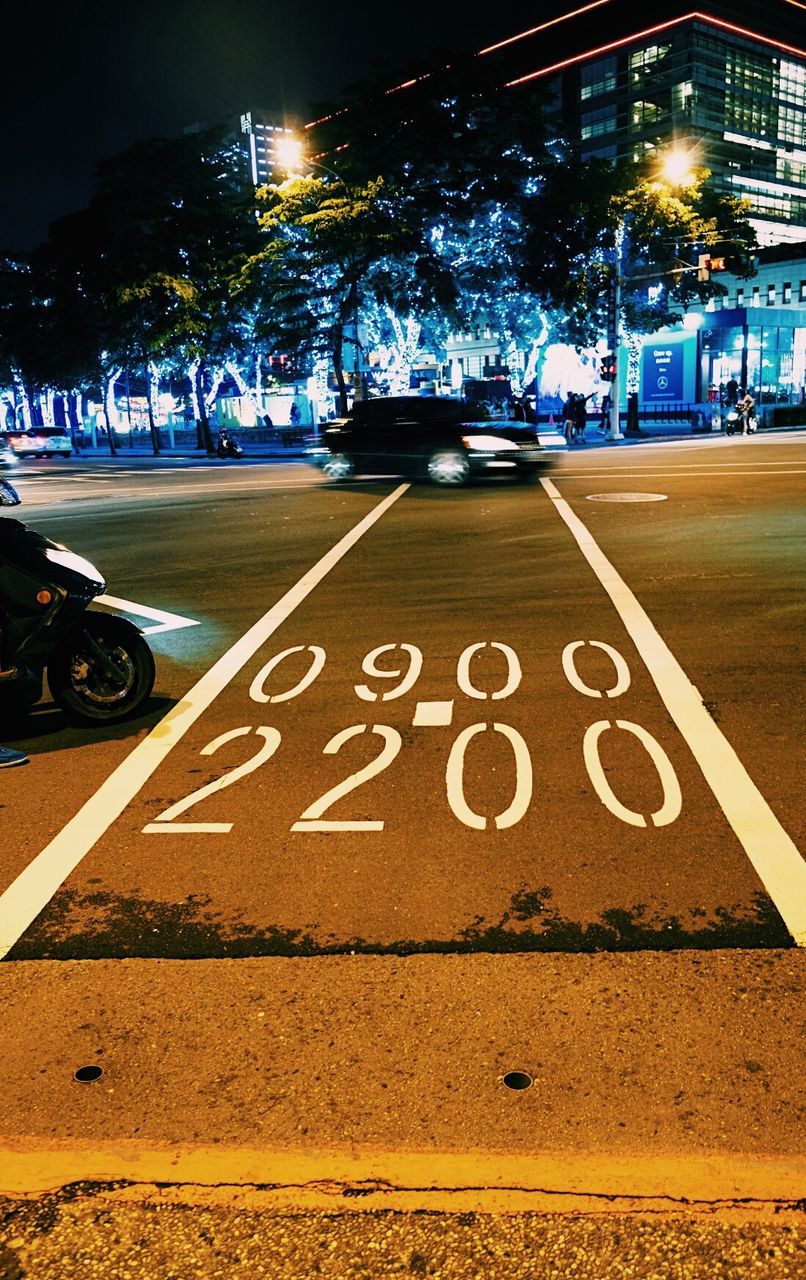 VIEW OF CARS ON ROAD AT NIGHT