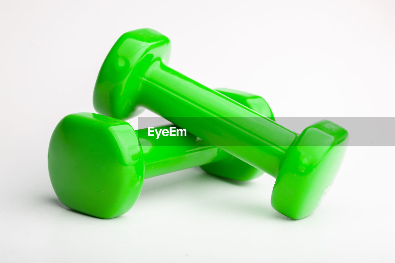 CLOSE-UP OF GREEN TOY ON WHITE BACKGROUND