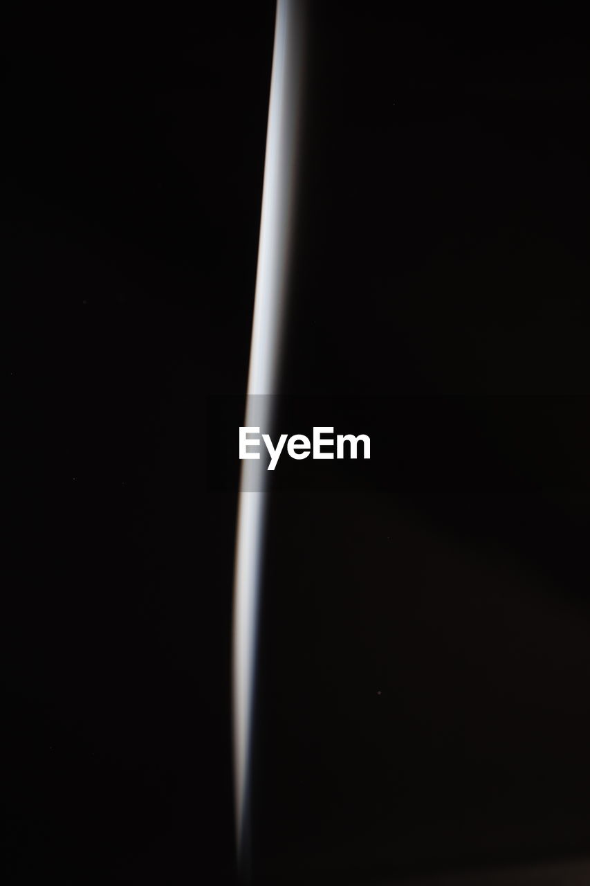 Close-up of light bulb against black background