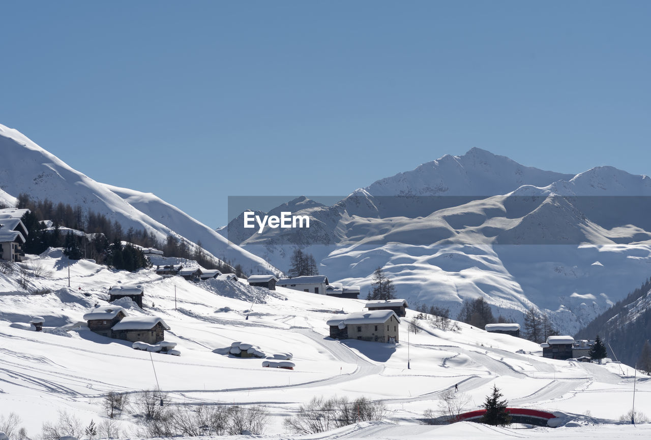 Scenic view of snowcapped mountains against clear sky