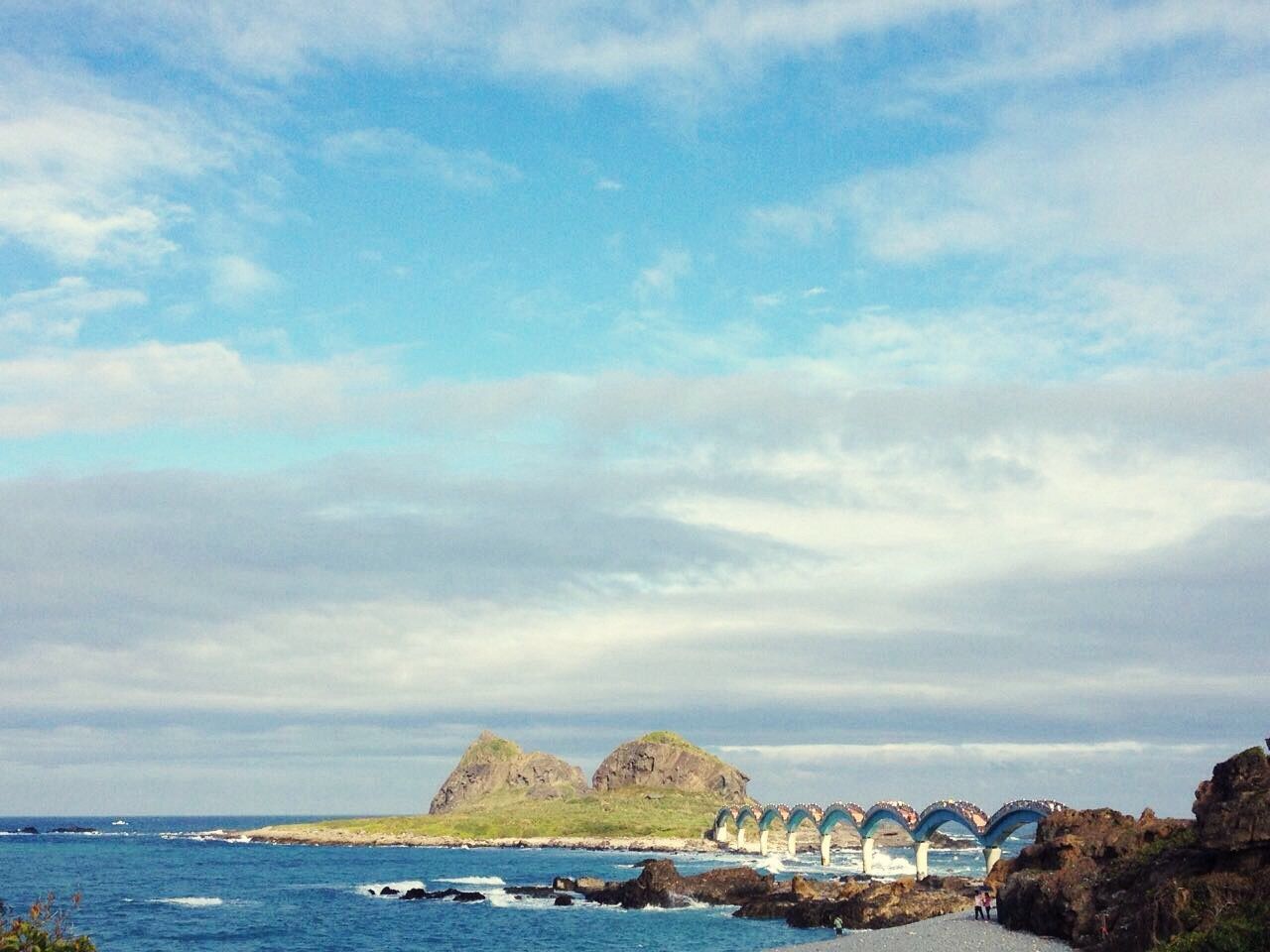 View of beach against cloudy sky