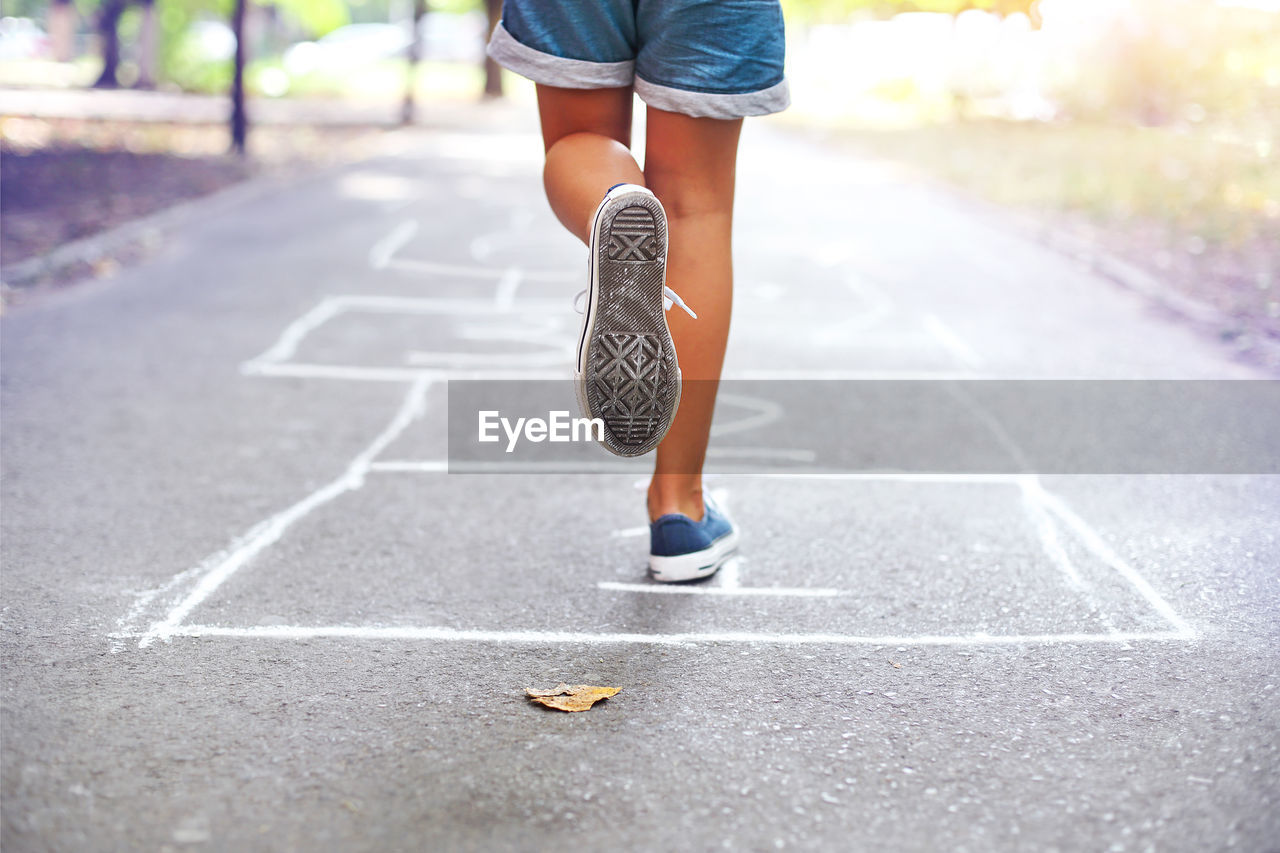 Low section of woman running on land