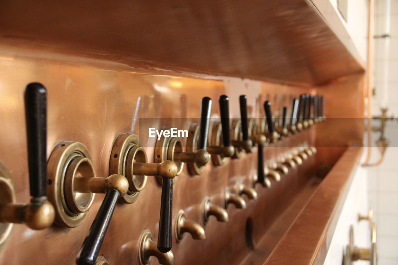 Close-up of beer taps in distillery