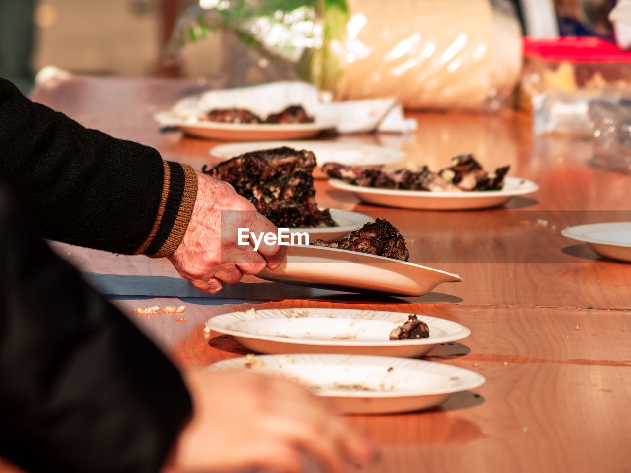 MIDSECTION OF PEOPLE PREPARING FOOD IN KITCHEN