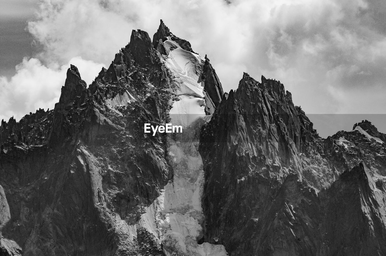 LOW ANGLE VIEW OF ROCK FORMATION AGAINST SKY