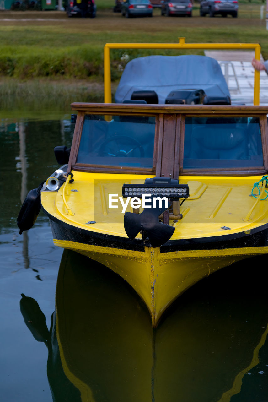 HIGH ANGLE VIEW OF YELLOW MOORED BOATS