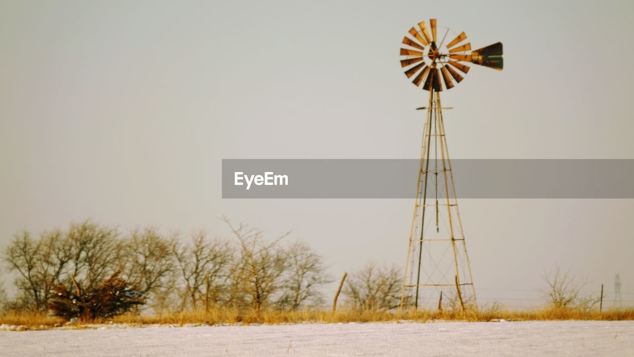 LOW ANGLE VIEW OF WINDMILLS AGAINST SKY