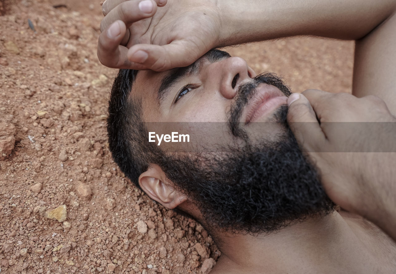 Close-up of young man lying down