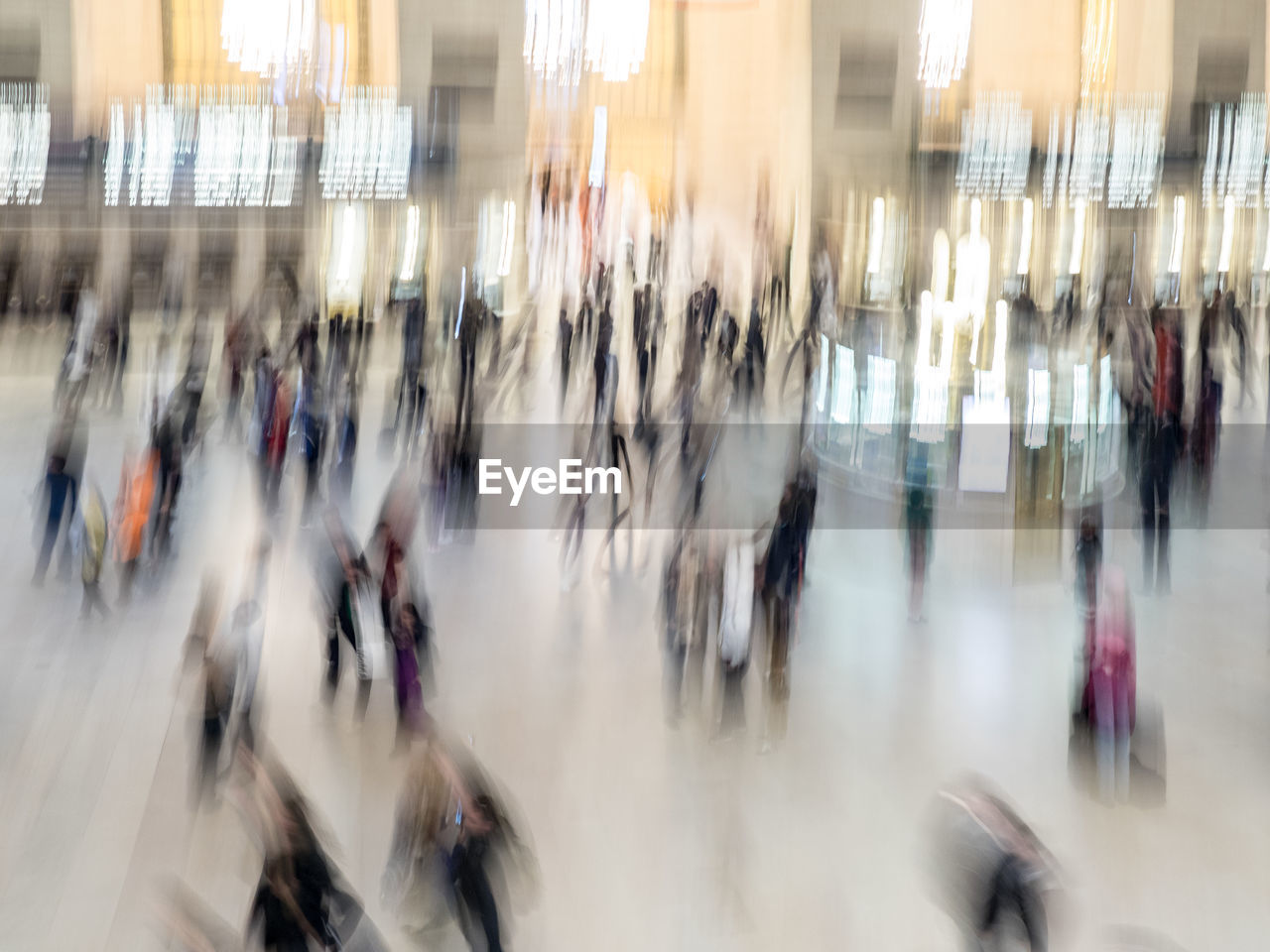 Blurred motion of people walking in city