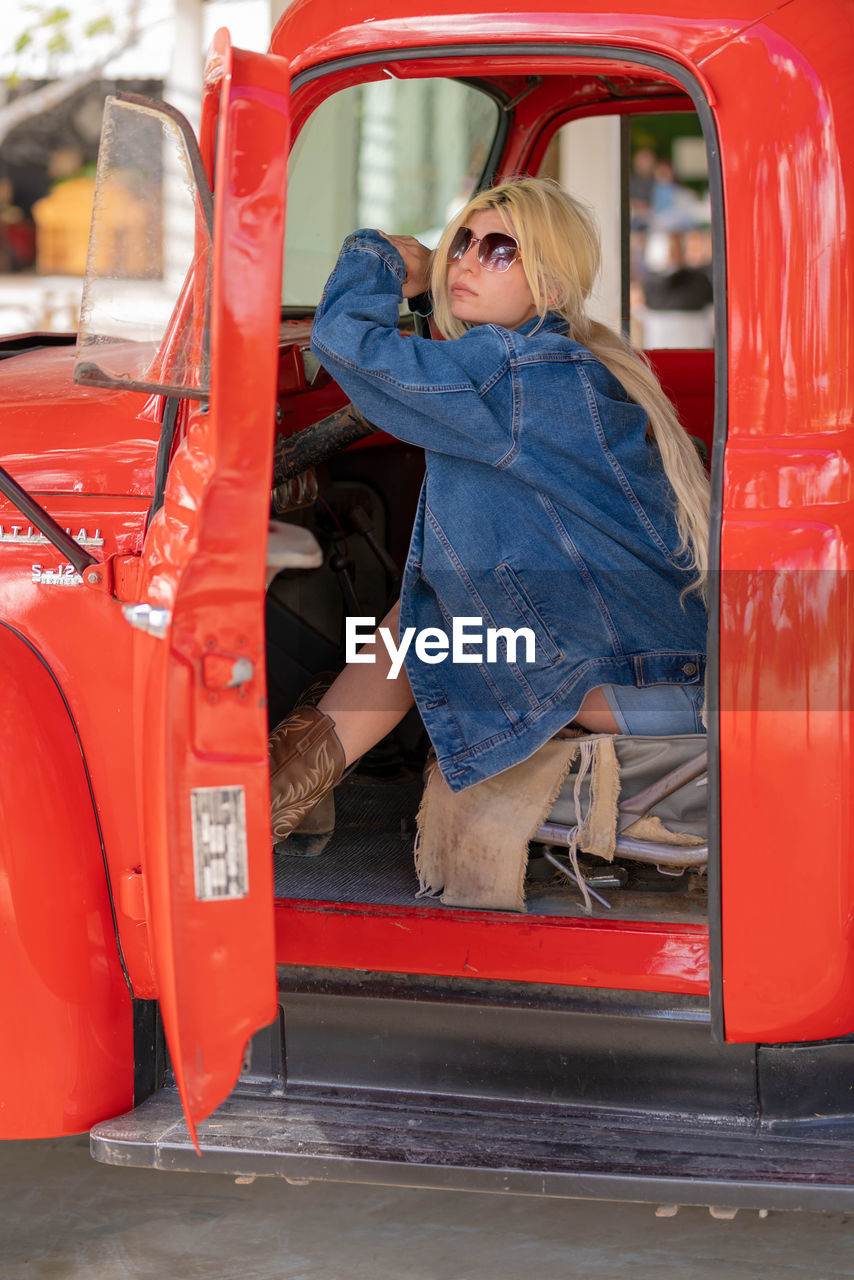 Portrait of young woman in car