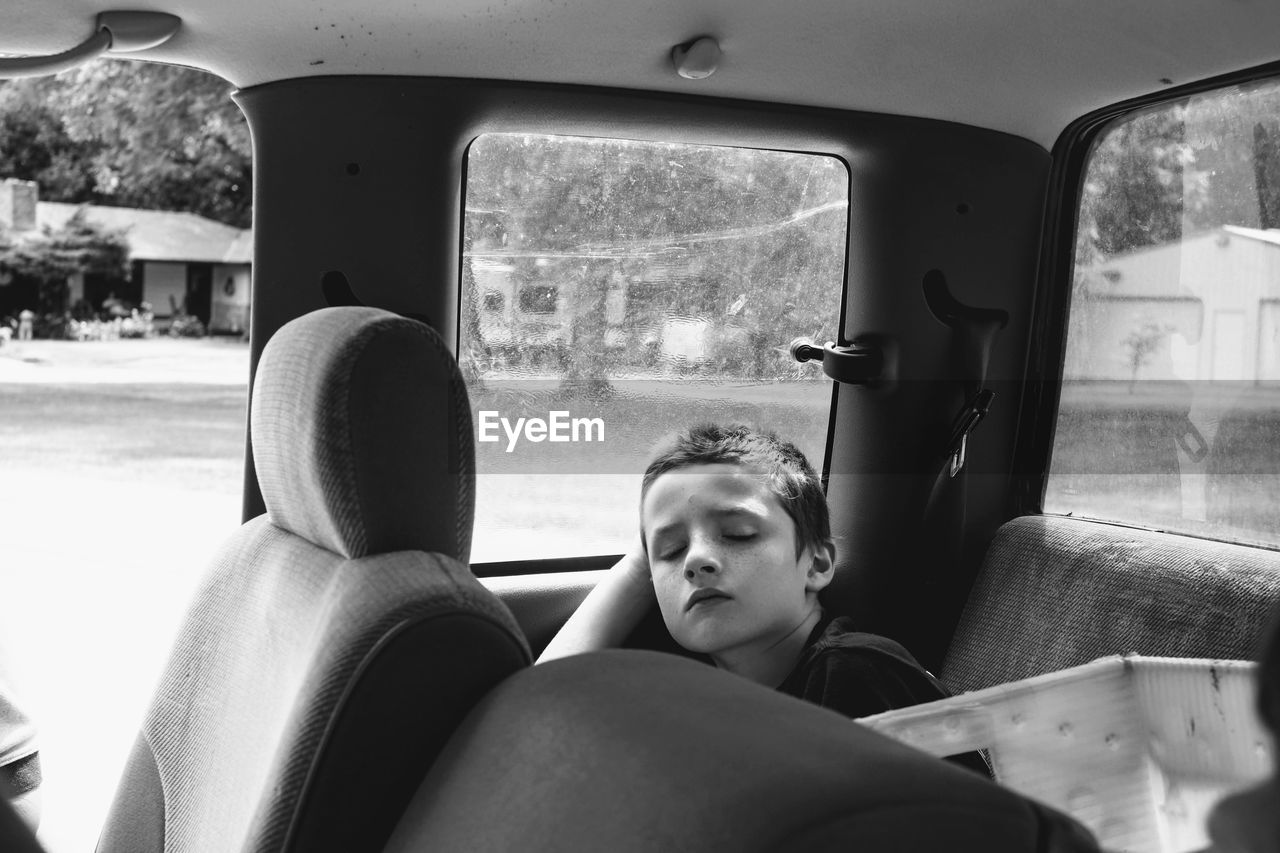 Boy sleeping in car