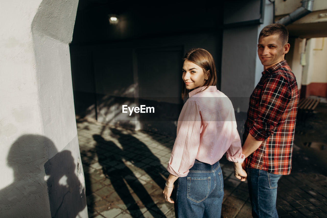 Portrait of smiling couple standing outdoors