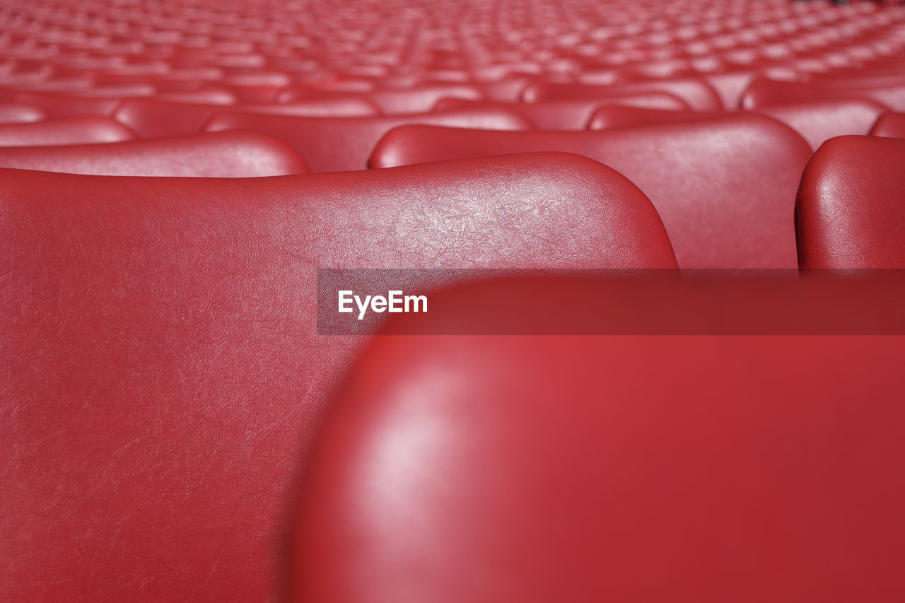 Full frame shot of empty red chairs in stadium