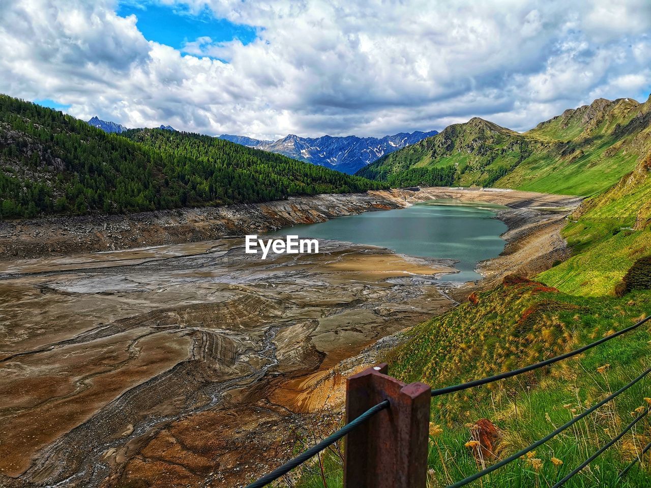 scenic view of mountains against cloudy sky