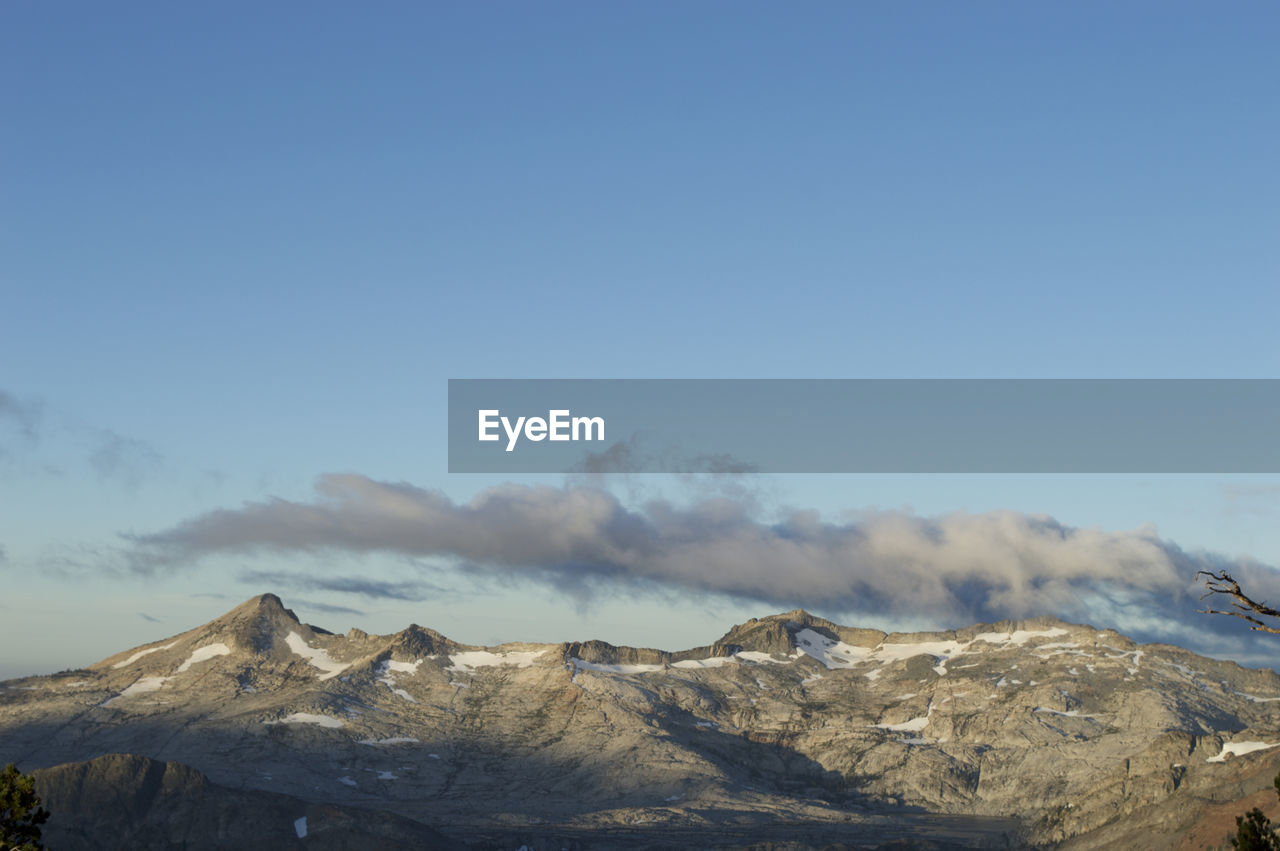 Scenic view of mountains against clear blue sky